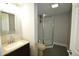 Bathroom featuring a vanity and mirror and a shower with glass doors at 4231 Carrollton Ave, Indianapolis, IN 46205