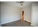 A bright bedroom featuring new gray flooring, fresh paint, and a modern ceiling fan for added comfort at 4231 Carrollton Ave, Indianapolis, IN 46205