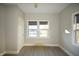Sun-filled bedroom with modern flooring, neutral walls, and a large double window at 4231 Carrollton Ave, Indianapolis, IN 46205