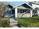 Charming blue home featuring a welcoming front porch and beautifully landscaped yard at 4231 Carrollton Ave, Indianapolis, IN 46205