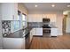 Updated kitchen featuring stainless steel appliances, granite counters, and white cabinets at 4231 Carrollton Ave, Indianapolis, IN 46205