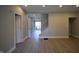 Open-concept living room with freshly painted neutral-toned walls and modern light-colored laminate floors at 4231 Carrollton Ave, Indianapolis, IN 46205