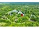 Aerial view with red marker showing the property's location surrounded by greenery and water features at 429 E Hoover Dr, Nineveh, IN 46164