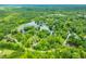 Aerial view of a lush, wooded landscape featuring a serene lake, highlighting the natural beauty and recreational opportunities nearby at 429 E Hoover Dr, Nineveh, IN 46164