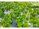 Aerial view of a lakefront community surrounded by mature trees at 429 E Hoover Dr, Nineveh, IN 46164