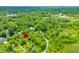 Stunning aerial view of a property marked with a red pin, nestled amidst lush greenery and a tranquil lake, showcasing its seclusion at 429 E Hoover Dr, Nineveh, IN 46164