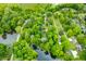 Aerial view of a lakefront community surrounded by mature trees at 429 E Hoover Dr, Nineveh, IN 46164