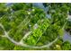 Aerial view outlining a wooded property with lake access, showcasing natural beauty and privacy at 429 E Hoover Dr, Nineveh, IN 46164