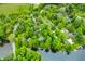 Aerial view of a wooded lot with a defined border, mature trees, home, and lake access at 429 E Hoover Dr, Nineveh, IN 46164
