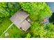 Aerial view showcasing the home, its deck, and a private dock surrounded by lush greenery at 429 E Hoover Dr, Nineveh, IN 46164