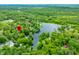 Aerial view with red marker displays property near lake surrounded by lush greenery and natural beauty at 429 E Hoover Dr, Nineveh, IN 46164