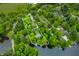 Aerial view of a wooded lot with a defined border, mature trees, home, and lake access at 429 E Hoover Dr, Nineveh, IN 46164