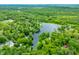 Stunning aerial view of a lake surrounded by lush trees and several houses with private docks at 429 E Hoover Dr, Nineveh, IN 46164