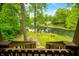 Scenic backyard view features a lush lawn leading to a serene creek at 429 E Hoover Dr, Nineveh, IN 46164