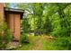 Serene backyard view with mature trees, leading to a tranquil waterfront and private dock at 429 E Hoover Dr, Nineveh, IN 46164