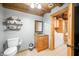 Cozy bathroom with vanity, toilet, and adjacent laundry area at 429 E Hoover Dr, Nineveh, IN 46164