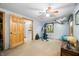 Spacious bedroom featuring a ceiling fan, exercise equipment, and natural light from the window at 429 E Hoover Dr, Nineveh, IN 46164