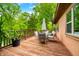 Inviting wooden deck with outdoor seating area, perfect for enjoying serene wooded views at 429 E Hoover Dr, Nineveh, IN 46164