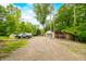 Spacious driveway leading to a home with a detached garage and lush surrounding landscape at 429 E Hoover Dr, Nineveh, IN 46164