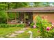 Charming home exterior with a covered porch, well-maintained lawn, and lovely flowering bushes at 429 E Hoover Dr, Nineveh, IN 46164