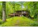 Exterior shot of a cabin with a deck, stone pathway, and hillside setting at 429 E Hoover Dr, Nineveh, IN 46164