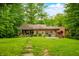 Inviting home with a covered porch, grill, and outdoor seating on a well-manicured lawn at 429 E Hoover Dr, Nineveh, IN 46164
