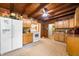 Charming kitchen featuring wood-paneled walls, light wood cabinetry, granite countertops and white appliances at 429 E Hoover Dr, Nineveh, IN 46164