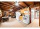Warm kitchen features wood ceiling, tile floors, and classic white appliances, seamlessly blending style and functionality at 429 E Hoover Dr, Nineveh, IN 46164