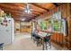 Charming kitchen boasts wood-paneled walls and ceiling, tile floor, and a view through the large window at 429 E Hoover Dr, Nineveh, IN 46164