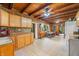 Spacious kitchen with natural wood cabinets, a stone accent wall, and tile flooring, combining rustic charm with practicality at 429 E Hoover Dr, Nineveh, IN 46164
