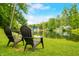 Relaxing waterfront view with comfortable chairs overlooking a serene lake and the calming greenery at 429 E Hoover Dr, Nineveh, IN 46164