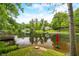 Picturesque lake view with lush greenery, a red umbrella, and inviting water perfect for recreation and relaxation at 429 E Hoover Dr, Nineveh, IN 46164