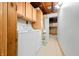 Functional laundry room with washer, dryer, cabinets, and storage at 429 E Hoover Dr, Nineveh, IN 46164