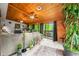 Inviting living room with a large sectional sofa, wooden ceiling, and a sliding door to the serene outdoor scenery at 429 E Hoover Dr, Nineveh, IN 46164
