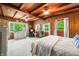 Bright main bedroom offering wood-paneled walls, beam ceiling and calming views of the surrounding nature at 429 E Hoover Dr, Nineveh, IN 46164