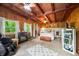 Serene main bedroom with wood-paneled walls, beam ceiling and soothing view of lush green scenery at 429 E Hoover Dr, Nineveh, IN 46164