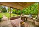 Relaxing back porch offering wood flooring, rustic furniture, and tranquil views of the backyard at 429 E Hoover Dr, Nineveh, IN 46164