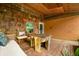 Charming back porch featuring wood finishes, outdoor seating, and a rustic tree stump table at 429 E Hoover Dr, Nineveh, IN 46164