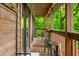 Cozy porch view with wood accents, outdoor seating, and serene greenery at 429 E Hoover Dr, Nineveh, IN 46164