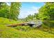 Waterfront view showcasing a private dock, boat, and lush green shoreline at 429 E Hoover Dr, Nineveh, IN 46164