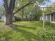Lush backyard with mature trees, a clothesline, and an enclosed porch, perfect for outdoor living at 4305 Clinton St, Lawrence, IN 46226