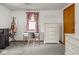 Bright bedroom with vintage-inspired decor, featuring a decorative dresser and a sunny window at 4305 Clinton St, Lawrence, IN 46226