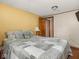Bedroom featuring a cozy bed with a quilt, bedside lamp, and ample natural light at 4305 Clinton St, Lawrence, IN 46226