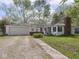 Exterior of home, with garage, and lawn at 4305 Clinton St, Lawrence, IN 46226