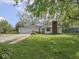 Charming single-story home with a brick chimney, attached garage, and a well-maintained lawn and landscaping at 4305 Clinton St, Lawrence, IN 46226