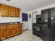 Kitchen features wood cabinets and black appliances at 4305 Clinton St, Lawrence, IN 46226