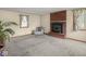 Living room with cozy fireplace, neutral carpet, and natural light at 4305 Clinton St, Lawrence, IN 46226
