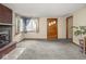 Inviting living room with new carpet, fireplace, and entry door at 4305 Clinton St, Lawrence, IN 46226