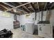 Functional unfinished basement with laundry hookups, painted walls and plenty of room for storage at 441 N Temple Ave, Indianapolis, IN 46201