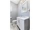Updated bathroom with sleek vanity, mirror, and walk-in shower with marble-like tiling at 441 N Temple Ave, Indianapolis, IN 46201